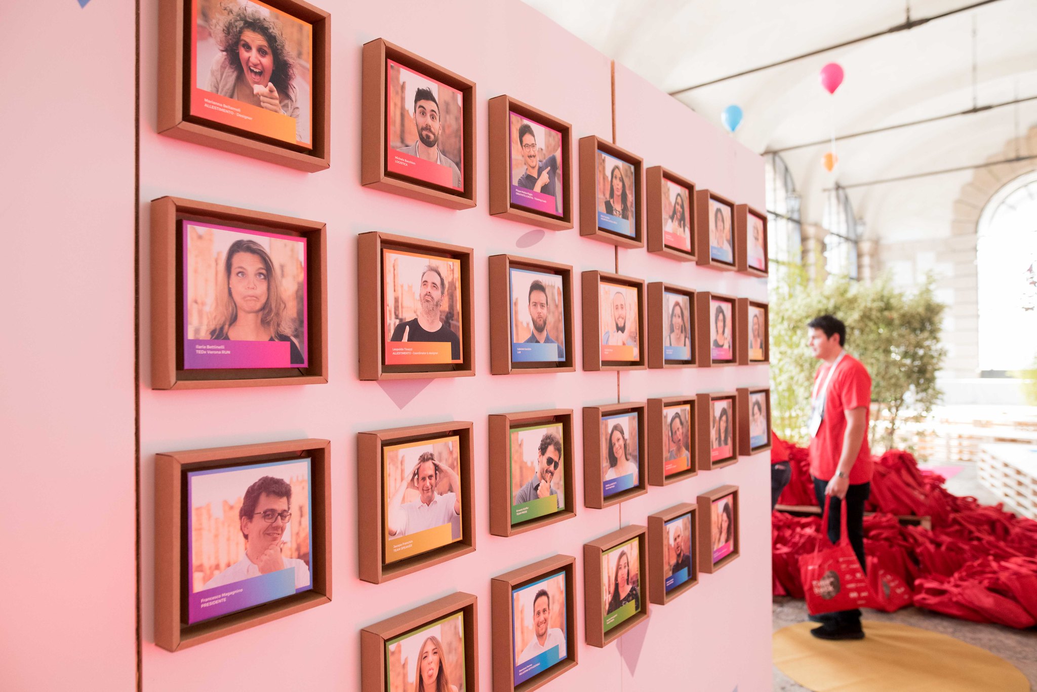 Speaker wall with framed portraits